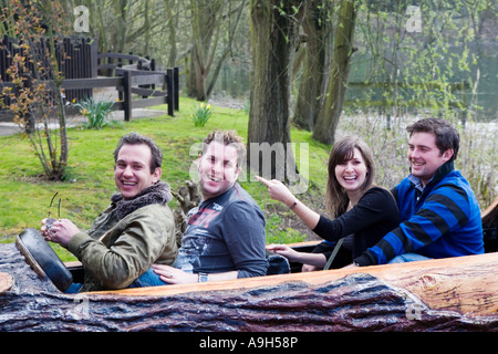 Group of young adults riding the Loggers Leap log flume ride at Thorpe Park Stock Photo