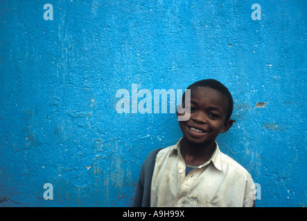 Young African boy in front of blue house near Beira Mozambique 2001 Stock Photo