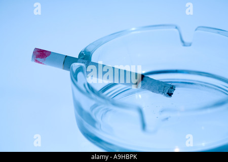 Burning Cigarette Lingering in Ashtray Stock Photo