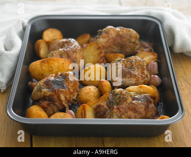 herb roast chicken in roasting tin Stock Photo