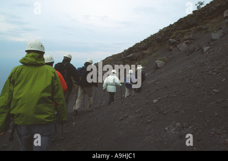 Walkers with volcanologist guide climbing Stromboli Volcano on island of Stromboli Sicily Stock Photo