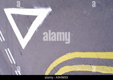 white and yellow painted road signs on tarmac Stock Photo