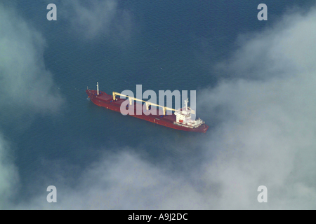 Aerial view of an oil tanker type ship at sea in the English Channel, seen through the clouds Stock Photo