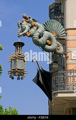 Casa Bruno Cuadros, Ramblas Art Deco dragon with laterne umbrella shop hanging on a house fassade , Barcelona , spain Stock Photo