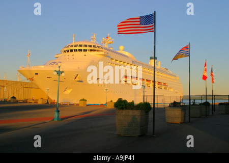 Regal Princess cruise ship docked at port of Victoria with flags flying Stock Photo