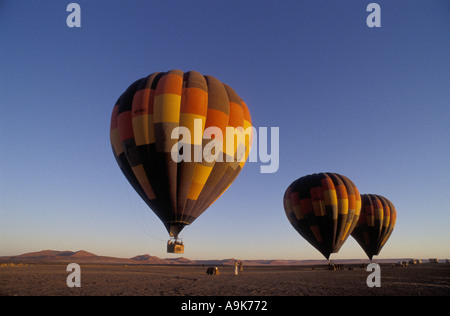 Three hot air balloons ready for take off at dawn in the Namib Naukluft National Park Namibia south west Africa Stock Photo