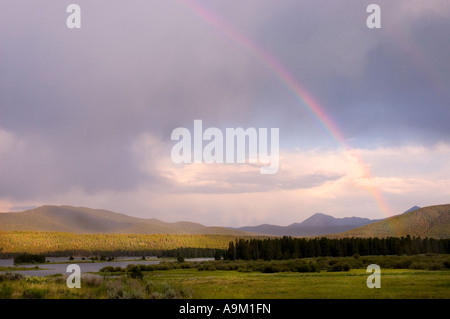 Colorado rainbow over mountains Stock Photo