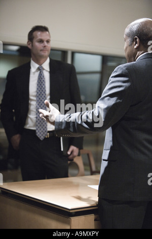 Two businessmen conversing in an office Stock Photo