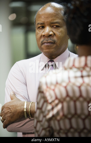 Close-up of businessman talking to colleague Stock Photo