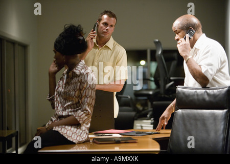 Businesspeople using mobile phones in office Stock Photo