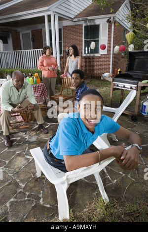 Portrait of African teenage boy with family and friends in background Stock Photo