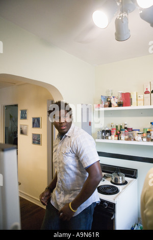 Young man standing in a kitchen Stock Photo