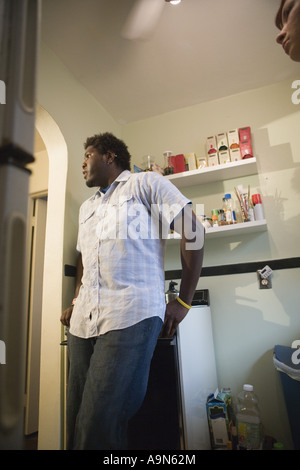 Young man standing in a kitchen Stock Photo