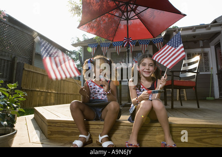 Two little girls in backyard celebrating the 4th of July Stock Photo