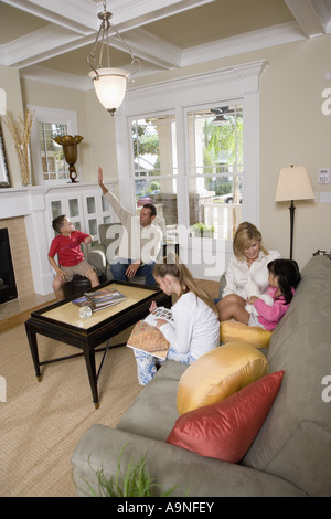 Family sitting together in the living room Stock Photo