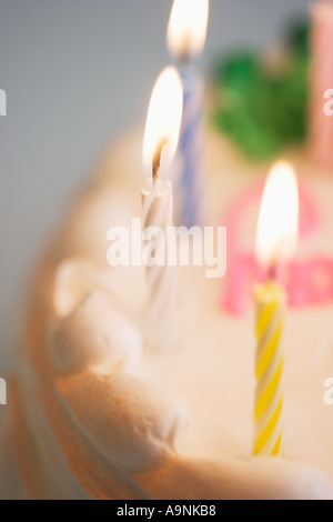 Lit happy Birthday candles on a birthday cake Stock Photo - Alamy
