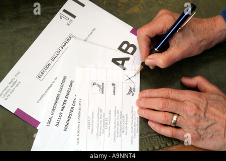 Completing a postal vote ballot paper. X cross marks the candidate selected. United Kingdom UK Stock Photo