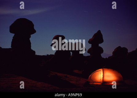 A glowing tent in Goblin Valley State Park UT Stock Photo