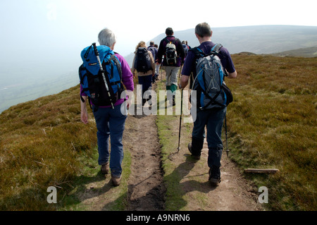 Guided walking group on Offa's Dyke footpath on Hatterrall Ridge forming the border of Wales and England UK Stock Photo