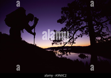 Silhouette of young man taking photographs at sunset in the Carpathian ...