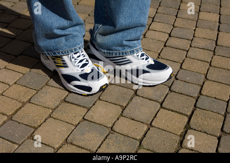 New trainers on a man wearing blue jeans Stock Photo - Alamy