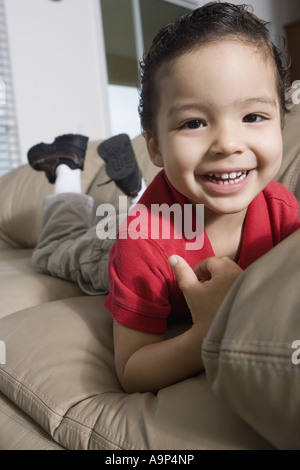 Portrait of a boy lying on a sofa Stock Photo