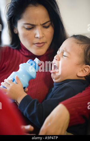 Mother holding crying little boy Stock Photo