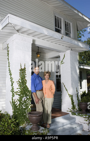 Portrait of a mature couple standing outside a house Stock Photo