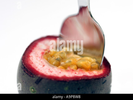 Passion fruit and spoon against white background Stock Photo