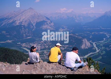 Tourists admiring Town of Banff and Area from Sulphur Mountain in Banff National Park in the Canadian Rockies in Alberta Canada Stock Photo