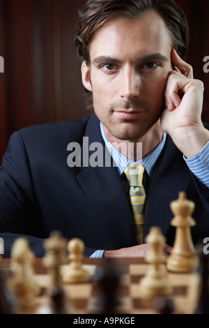 Businessman playing chess Stock Photo