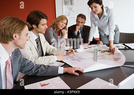 Businesspeople looking at plans Stock Photo
