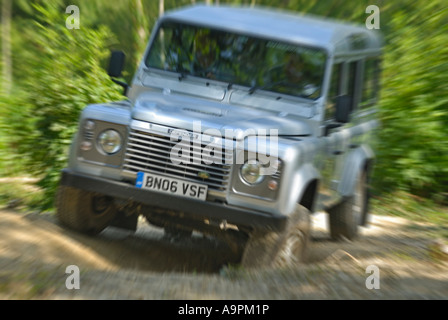 Off roading silver metallic Land Rover Defender 110 TD5 by Land Rover Experience used for driver training. Europe UK England. Stock Photo