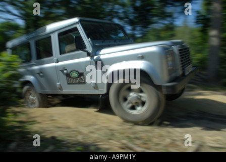 Off roading silver metallic Land Rover Defender 110 TD5 by Land Rover Experience used for driver training. Europe UK England. Stock Photo