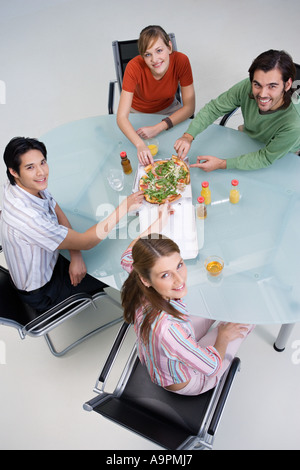 Colleagues sharing pizza Stock Photo