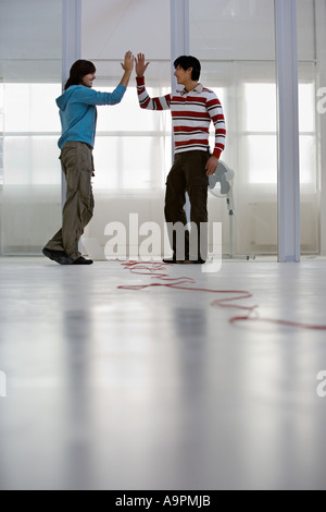 Colleagues doing a high five Stock Photo