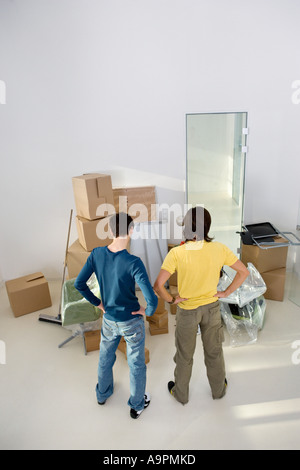 Young men looking at cardboard boxes Stock Photo