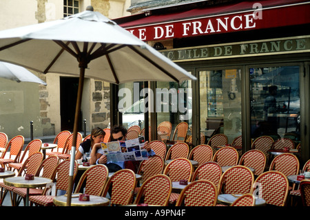 France Paris a couple reading a street map at an empty cafe Stock Photo