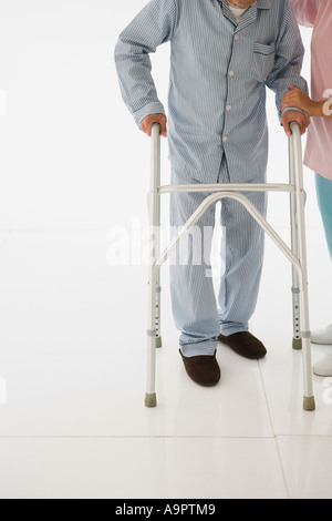 Nurse helping patient to walk Stock Photo