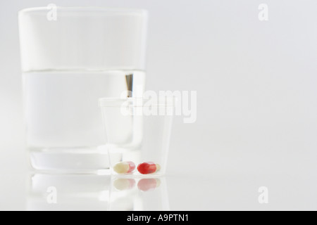 Pills with glass of water Stock Photo