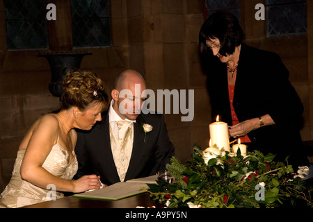 Bride and groom signing the register Stock Photo