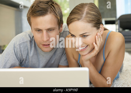 Mid adult couple using laptop Stock Photo