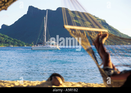 Relaxing in hammock on Huahine Island in South Pacific Stock Photo