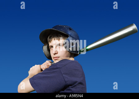 Teenage boy about to swing baseball bat Stock Photo