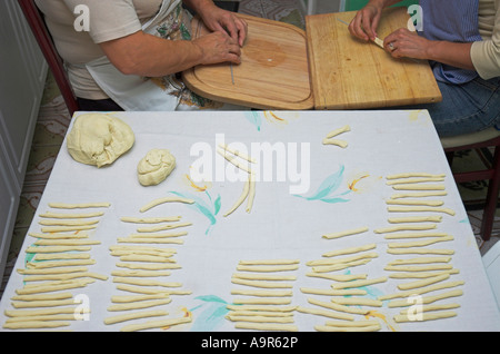 Italian mother and daughter making fresh pasta at home Stock Photo