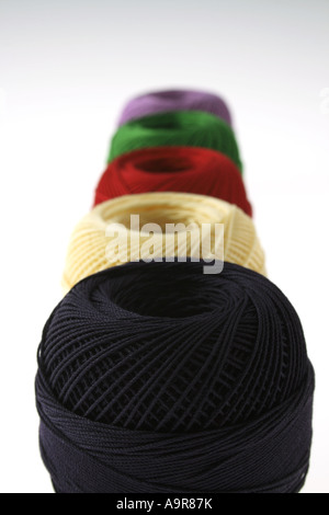 Spools of colored thread in a row Stock Photo
