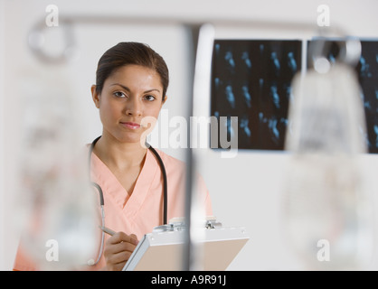 Indian female doctor writing on chart Stock Photo - Alamy