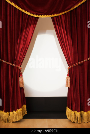 Screen behind open stage curtains Stock Photo