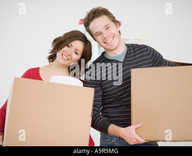 Couple carrying moving boxes Stock Photo