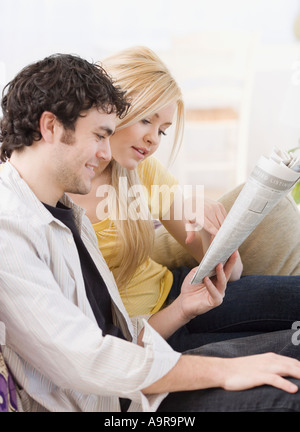 Couple reading newspaper Stock Photo